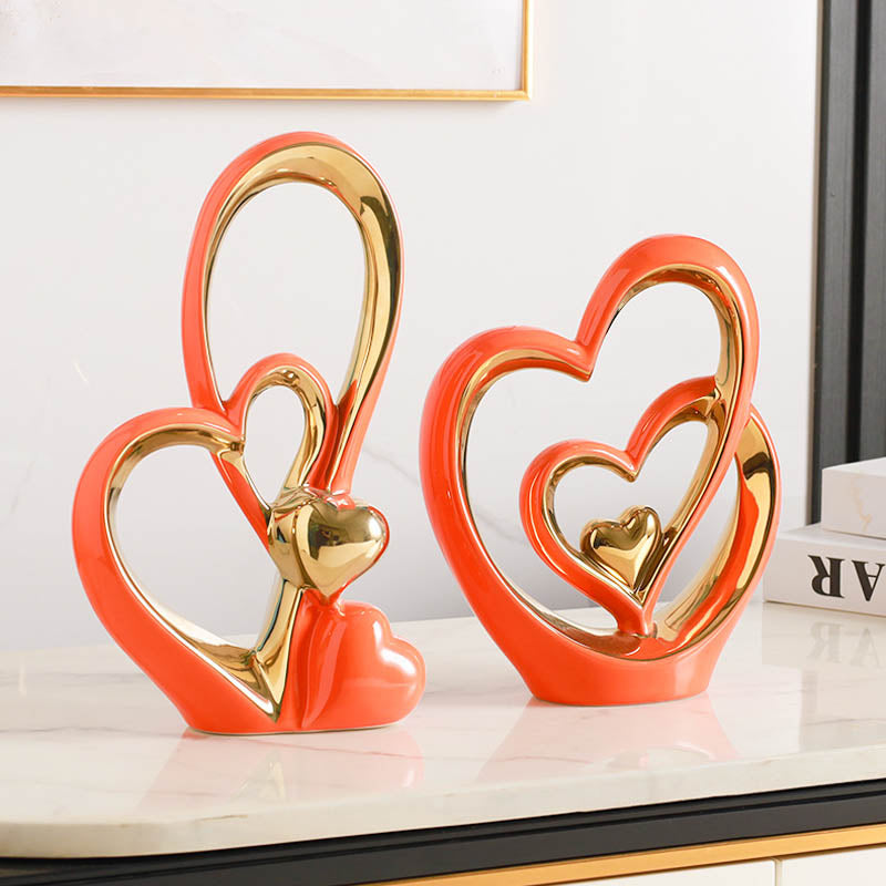 Golden Heart Intertwined Love Sculpture in coral ceramic with gold accents, showcasing intertwined hearts for a vibrant and romantic decor piece.