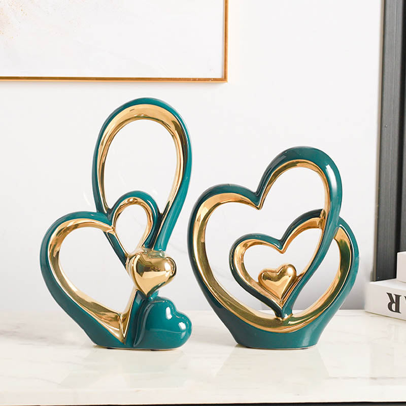 Golden Heart Intertwined Love Sculpture in teal ceramic with gold accents, featuring intertwined hearts for a stylish and romantic decor piece.