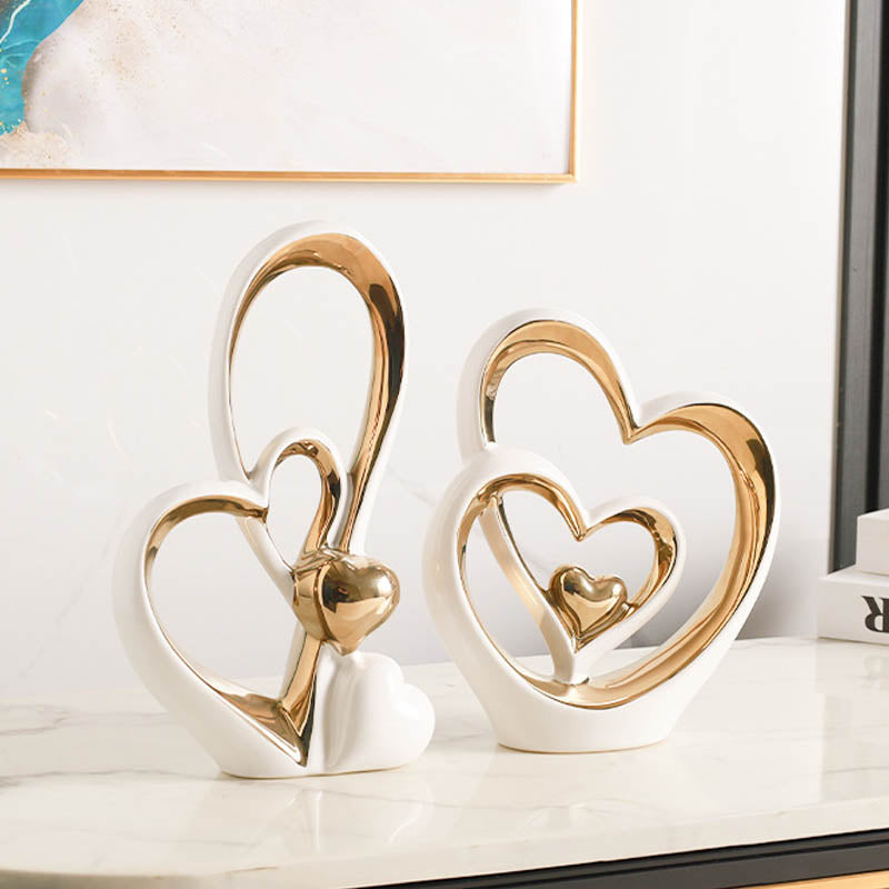 Golden Heart Intertwined Love Sculpture in sleek white ceramic with gold electroplated details, perfect for luxury home and romantic gifting.