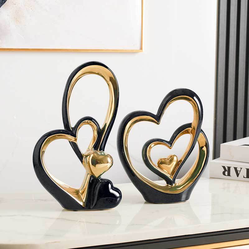 Golden Heart Intertwined Love Sculpture in black ceramic with gold accents, offering a bold and sophisticated touch to modern home decor.