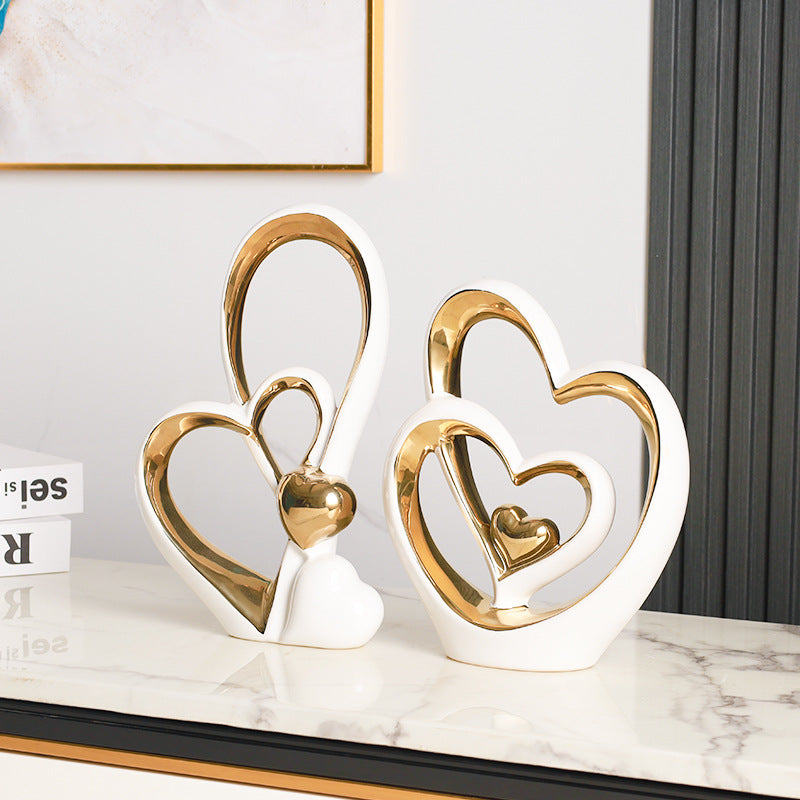 Golden Heart Intertwined Love Sculpture in white ceramic with electroplated gold accents, featuring elegant heart shapes for modern home decor.