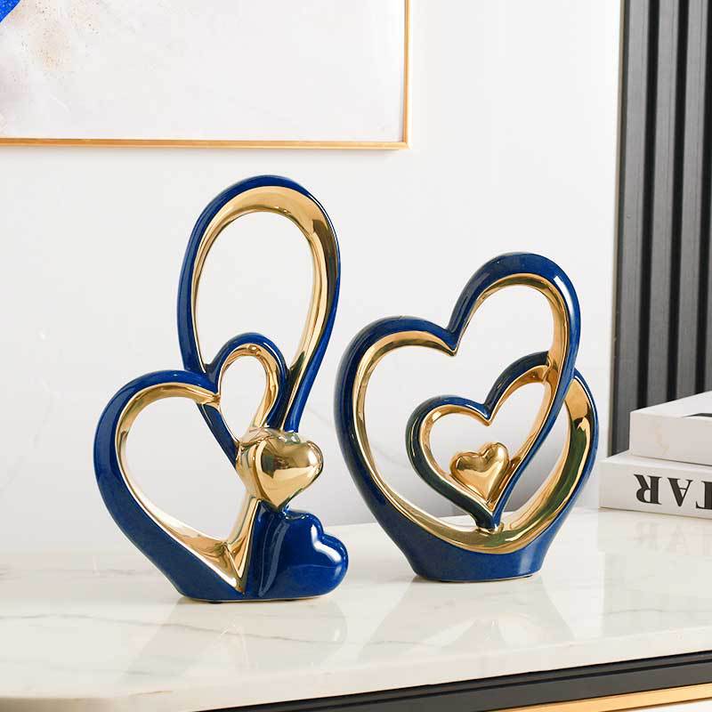 Golden Heart Intertwined Love Sculpture in royal blue ceramic with gold electroplated details, ideal for elegant and contemporary home decor.
