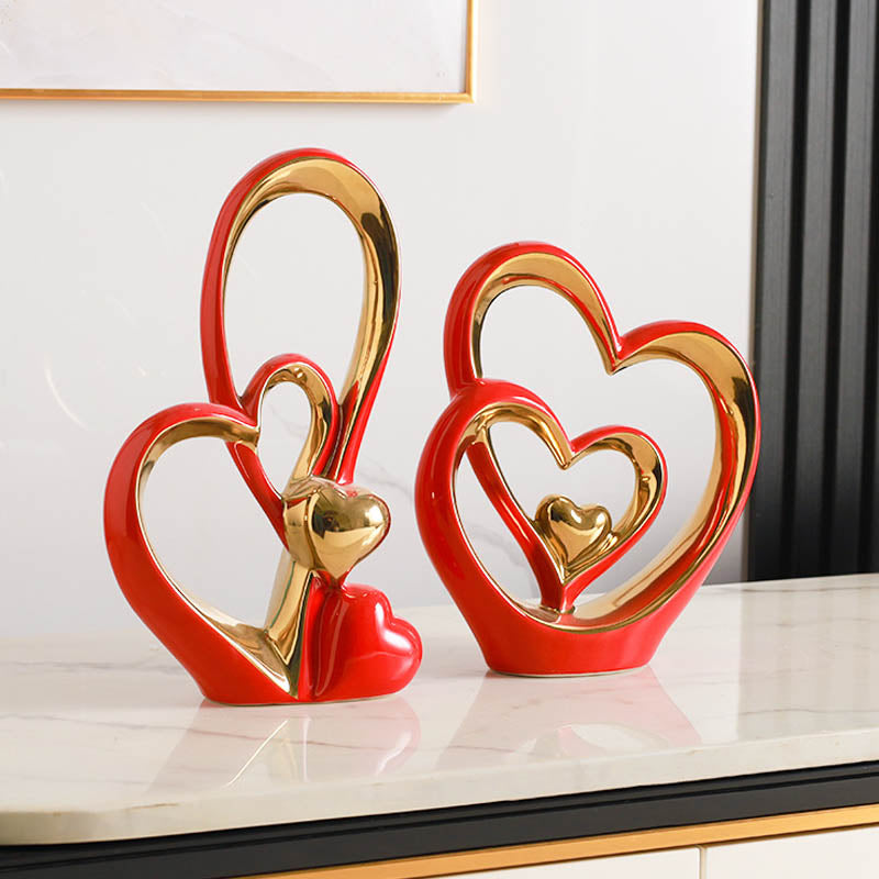 Golden Heart Intertwined Love Sculpture in red ceramic with gold electroplated details, perfect for romantic gifting and contemporary home decor.