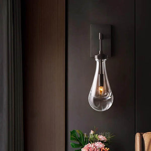 Raindrop Crystal Wall Light featuring premium brass and crystal, casting enchanting ripples of light.