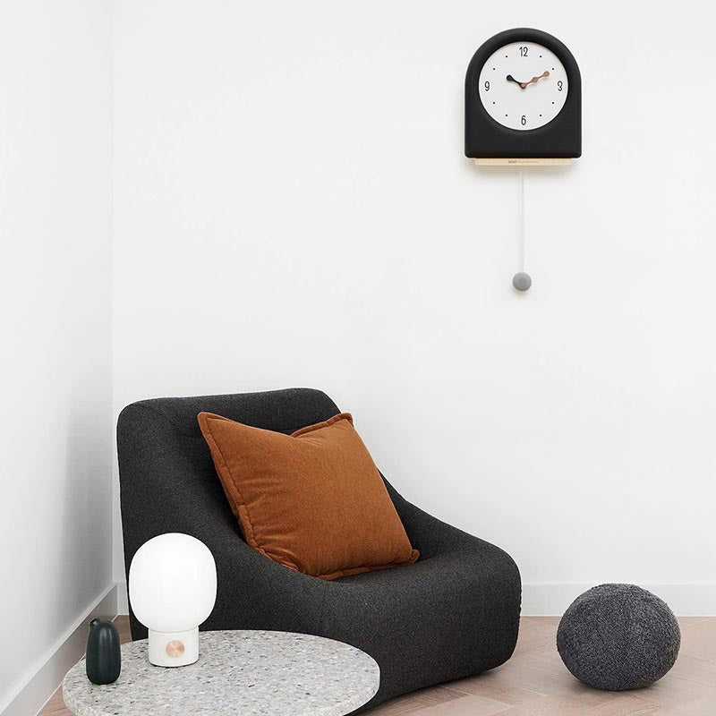 Time's Arc Pendulum Clock showcasing an elegant, minimalist design with a unique arched top and silent movement.