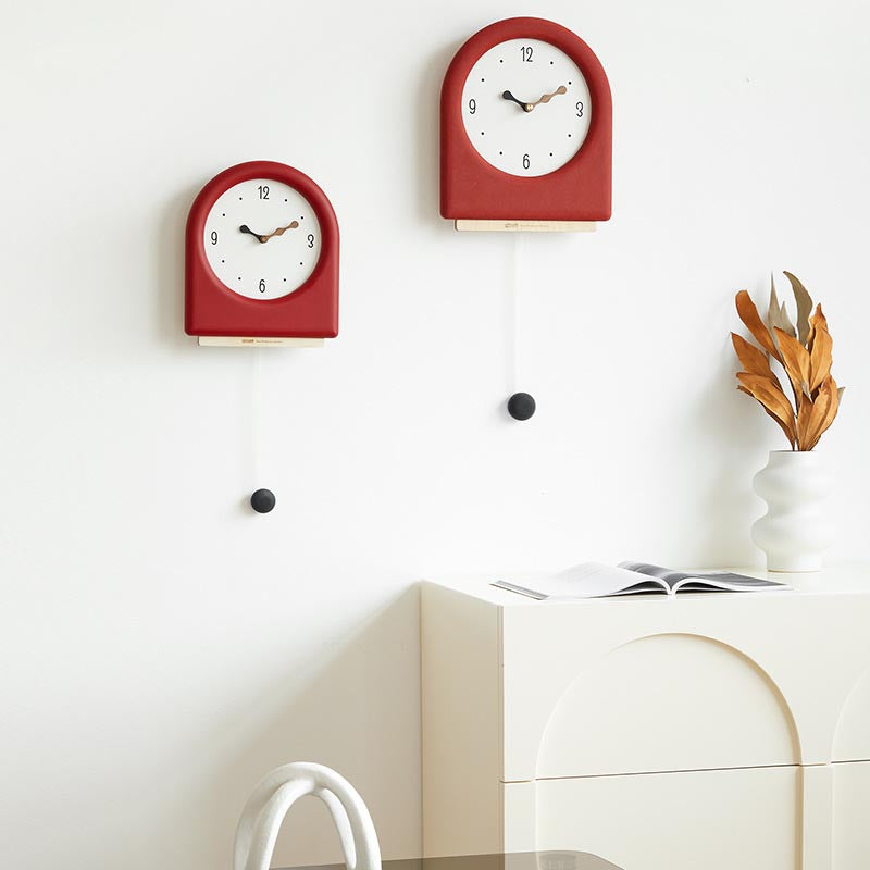 Time's Arc Pendulum Clock showcasing an elegant, minimalist design with a unique arched top and silent movement.