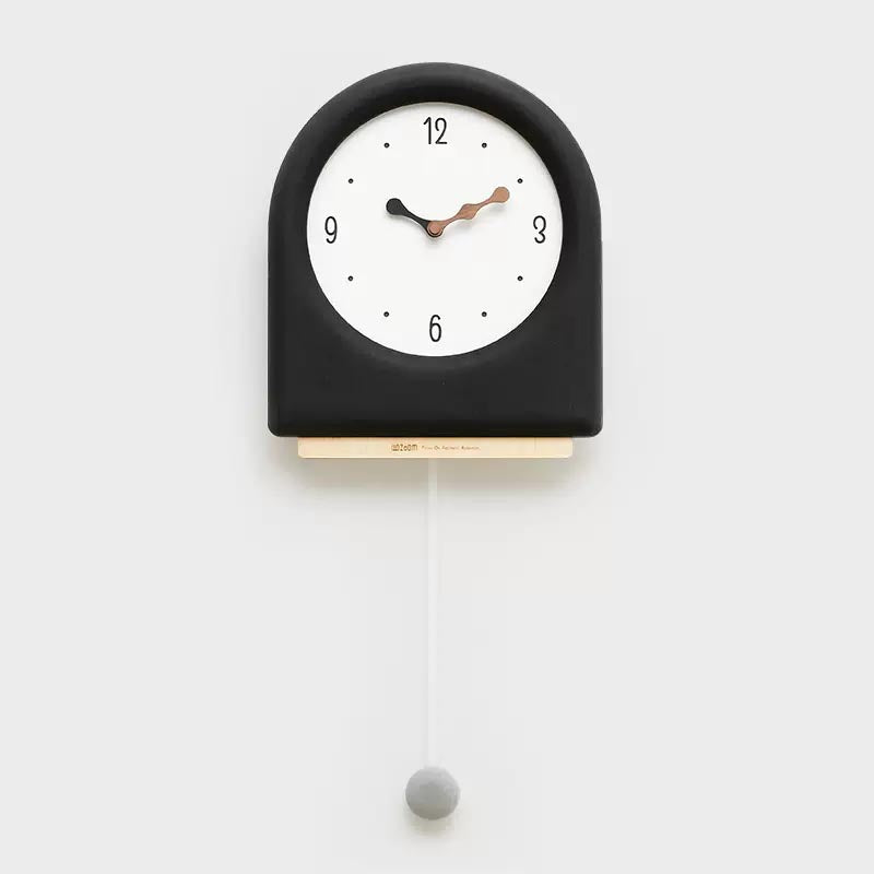 Time's Arc Pendulum Clock showcasing an elegant, minimalist design with a unique arched top and silent movement.