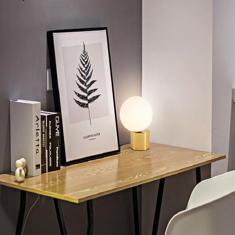 Illuminare Table Lamp showcasing its elegant design and gold-plated base on LuxusHeim.