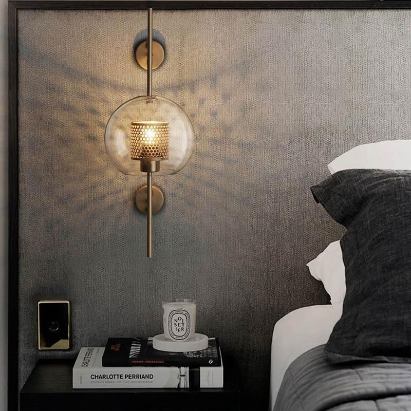 Honeycomb Radiance Orb Sconce elegantly illuminating a cozy living room corner with its soft, golden glow.