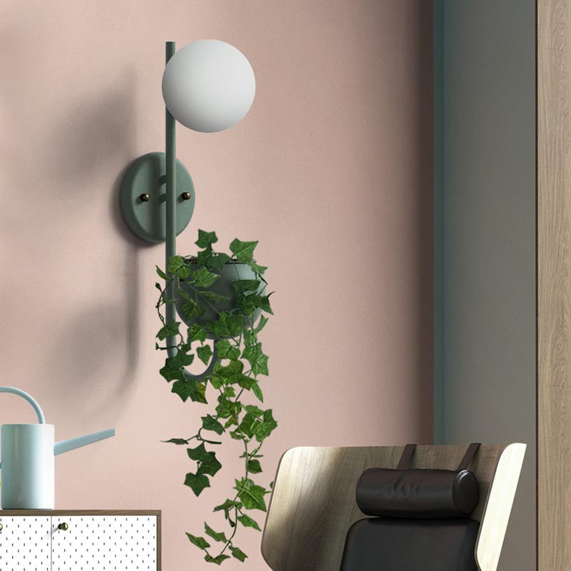 Verena Botanic Wall Lamp with an integrated plant holder in a cozy living room setting.