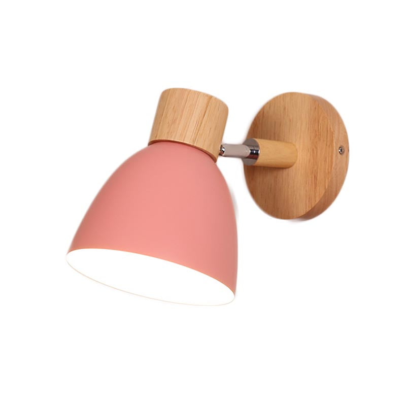 Vibrant Rotating Sconce in a cozy bedroom setting, showcasing its colorful finish.