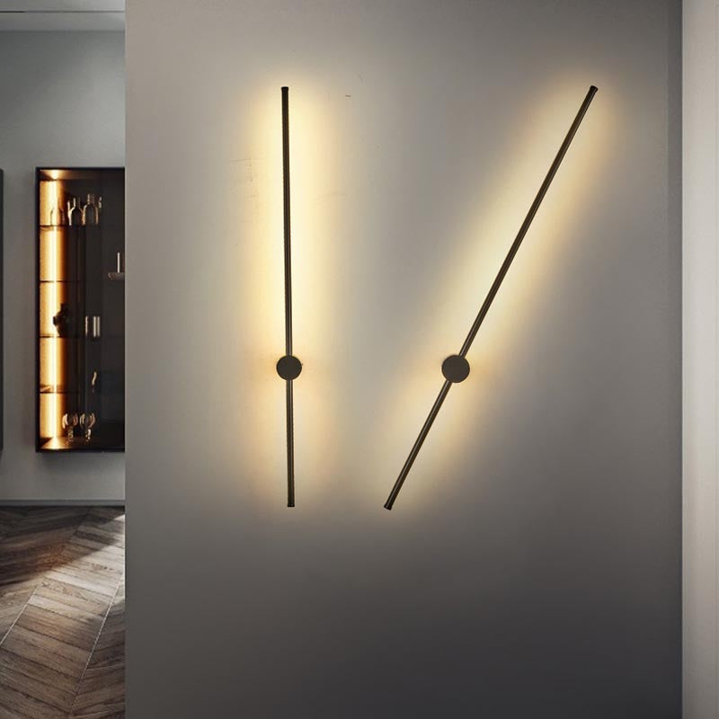 SleekLine LED Illuminator elegantly hung vertically in a modern living room, emitting a warm glow.