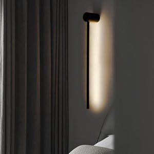 SleekLine LED Illuminator elegantly hung vertically in a modern living room, emitting a warm glow.