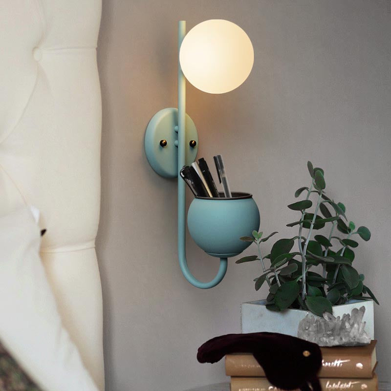 Verena Botanic Wall Lamp with an integrated plant holder in a cozy living room setting.