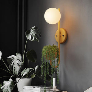 Verena Botanic Wall Lamp with an integrated plant holder in a cozy living room setting.