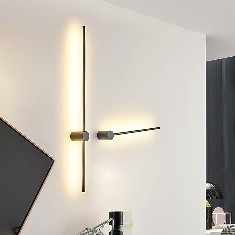 SleekLine LED Illuminator elegantly hung vertically in a modern living room, emitting a warm glow.