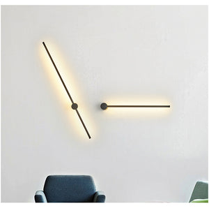 SleekLine LED Illuminator elegantly hung vertically in a modern living room, emitting a warm glow.