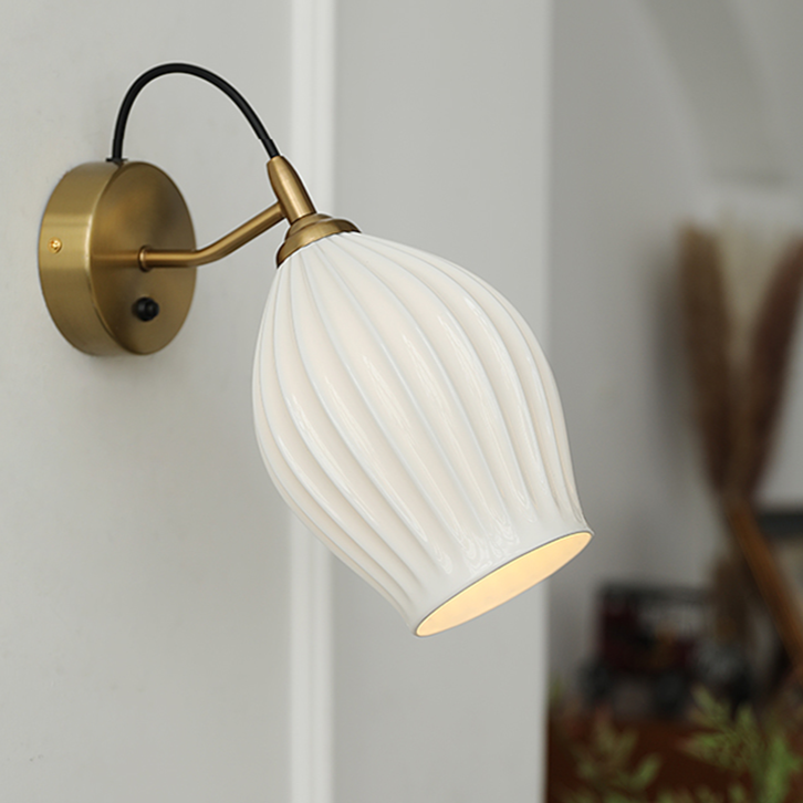 Celestia Pleated Ceramic Wall Sconce with a pleated ceramic lampshade and Chrome or Brass base, ideal for adding a touch of sophistication to any room.