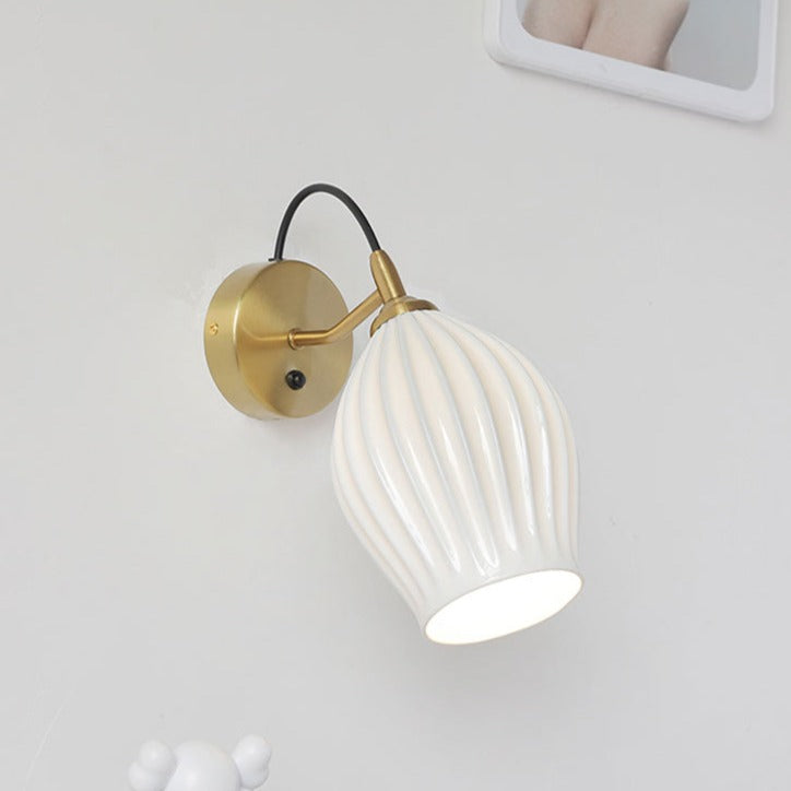 Celestia Pleated Ceramic Wall Sconce with a pleated ceramic lampshade and Chrome or Brass base, ideal for adding a touch of sophistication to any room.