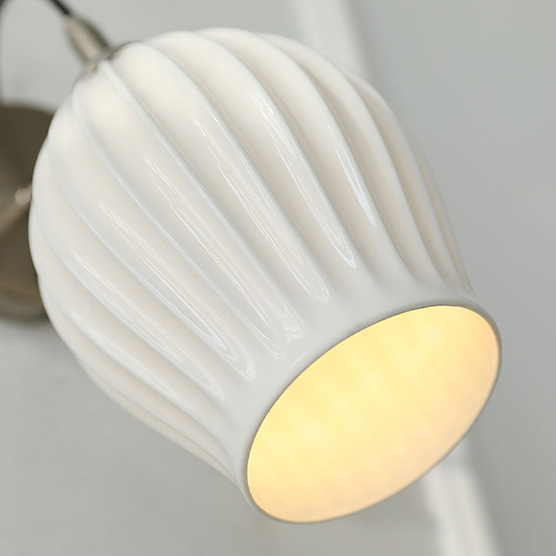 Celestia Pleated Ceramic Wall Sconce with a pleated ceramic lampshade and Chrome or Brass base, ideal for adding a touch of sophistication to any room.