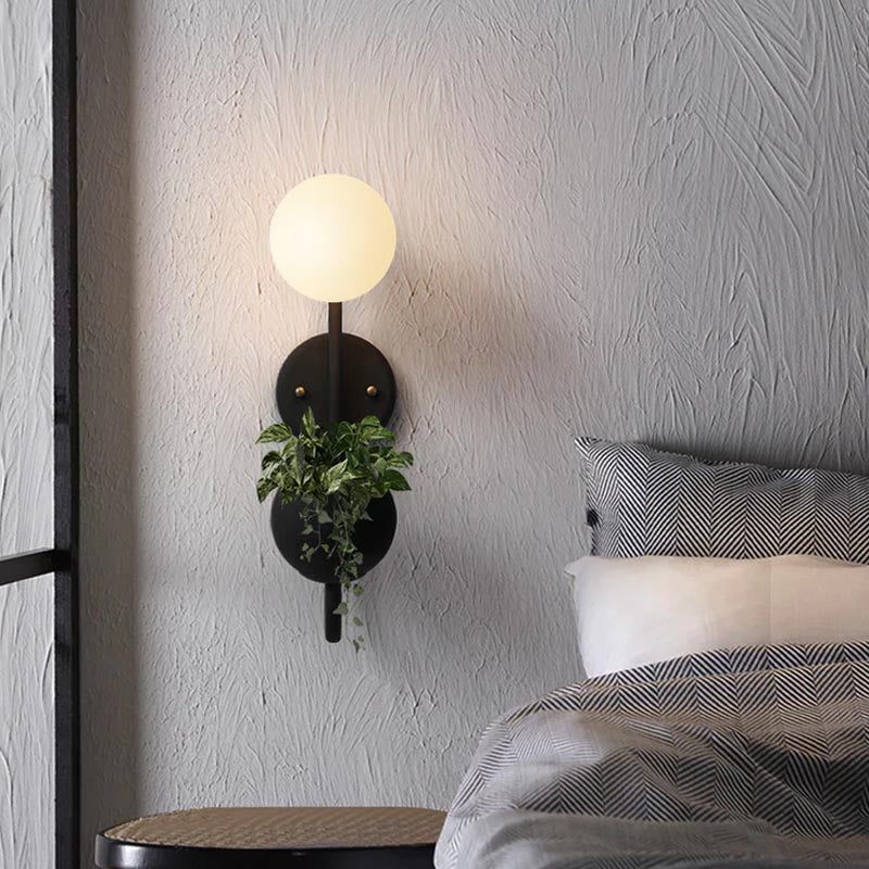 Verena Botanic Wall Lamp with an integrated plant holder in a cozy living room setting.