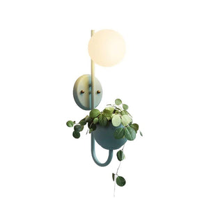 Verena Botanic Wall Lamp with an integrated plant holder in a cozy living room setting.