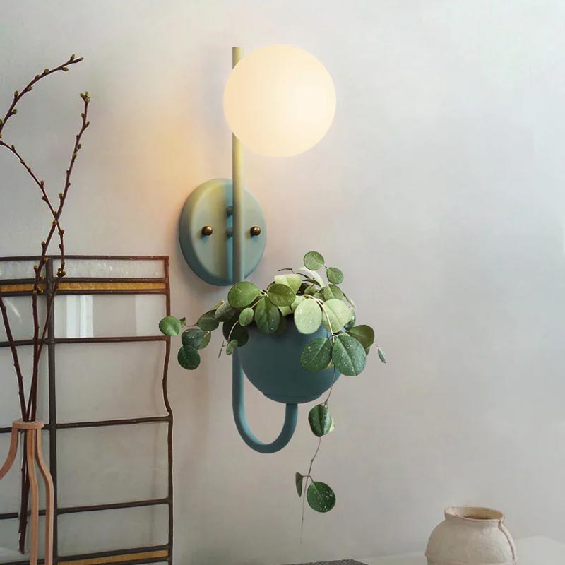 Verena Botanic Wall Lamp with an integrated plant holder in a cozy living room setting.