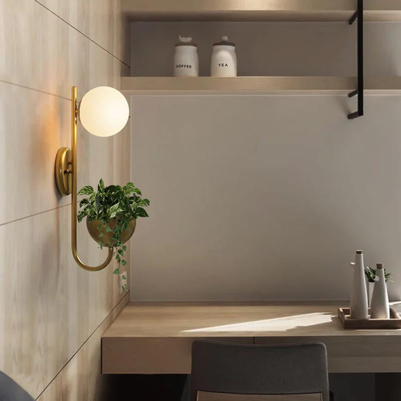 Verena Botanic Wall Lamp with an integrated plant holder in a cozy living room setting.