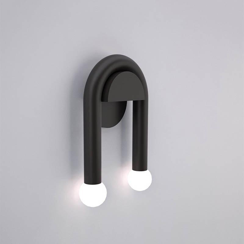 ArchLite Dual-Glow Wall Sconce elegantly lighting up a modern living room, showcasing its unique arched design.