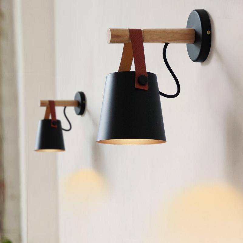 Rustic Elegance Belted Wall Lamp illuminating a cozy reading nook, showcasing its unique blend of metal, wood, and leather.