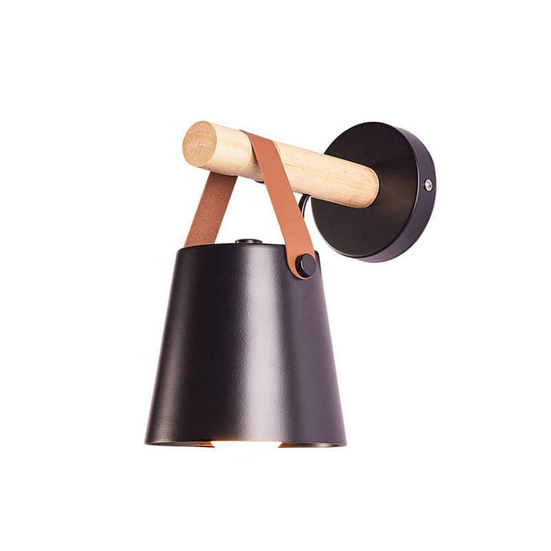 Rustic Elegance Belted Wall Lamp illuminating a cozy reading nook, showcasing its unique blend of metal, wood, and leather.