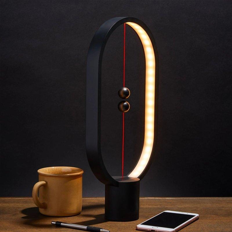 Heng Balance Desk Lamp showcasing its unique balance mechanism and sleek design on LuxusHeim.