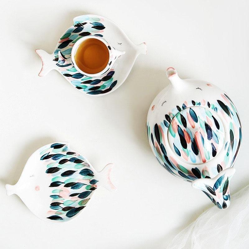 Kissy Fish Tea Set displayed on a dining table with tea and plates