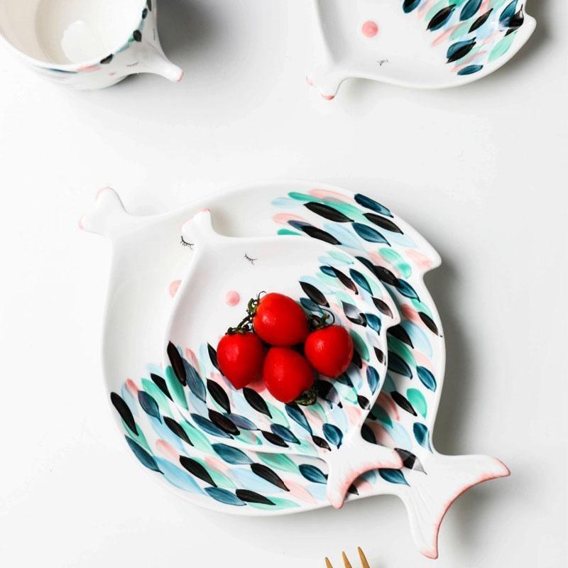 Kissy Fish Tea Set displayed on a dining table with tea and plates