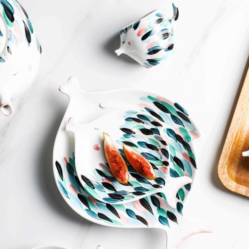 Kissy Fish Tea Set displayed on a dining table with tea and plates