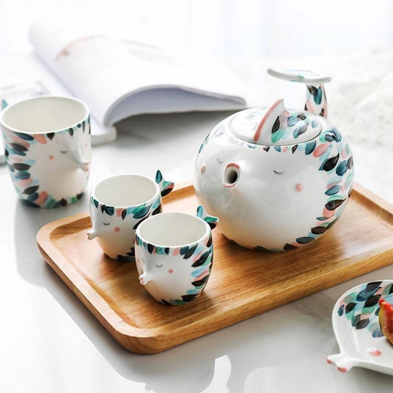 Kissy Fish Tea Set displayed on a dining table with tea and plates