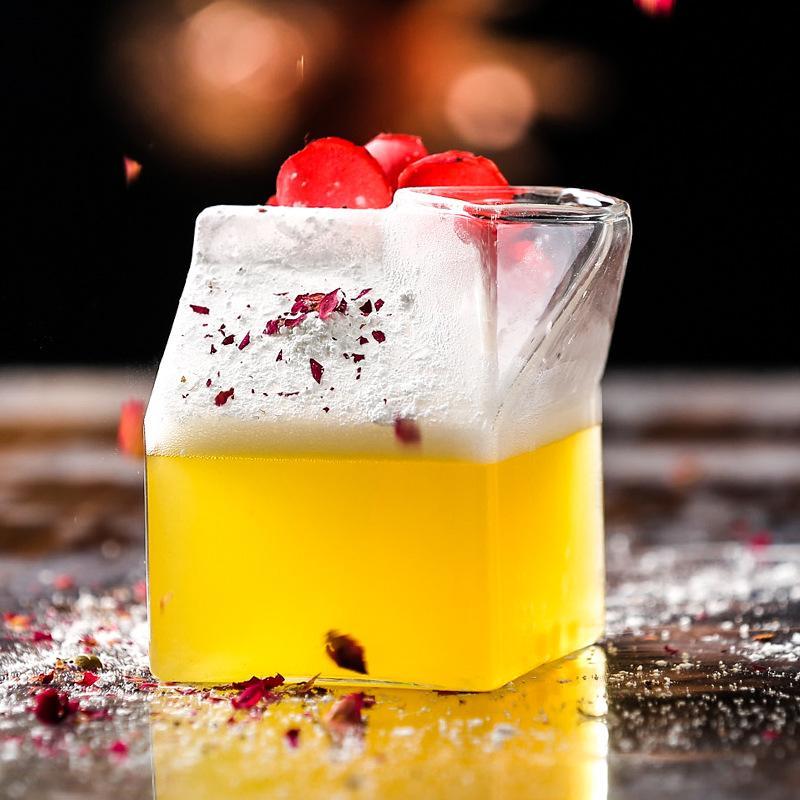 Premium Transparent Glass Milk Carton on a table with beverages