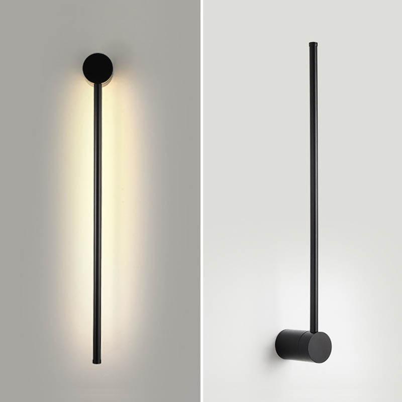 SleekLine LED Illuminator elegantly hung vertically in a modern living room, emitting a warm glow.