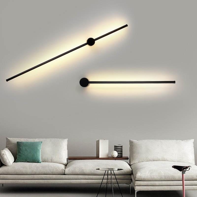 SleekLine LED Illuminator elegantly hung vertically in a modern living room, emitting a warm glow.