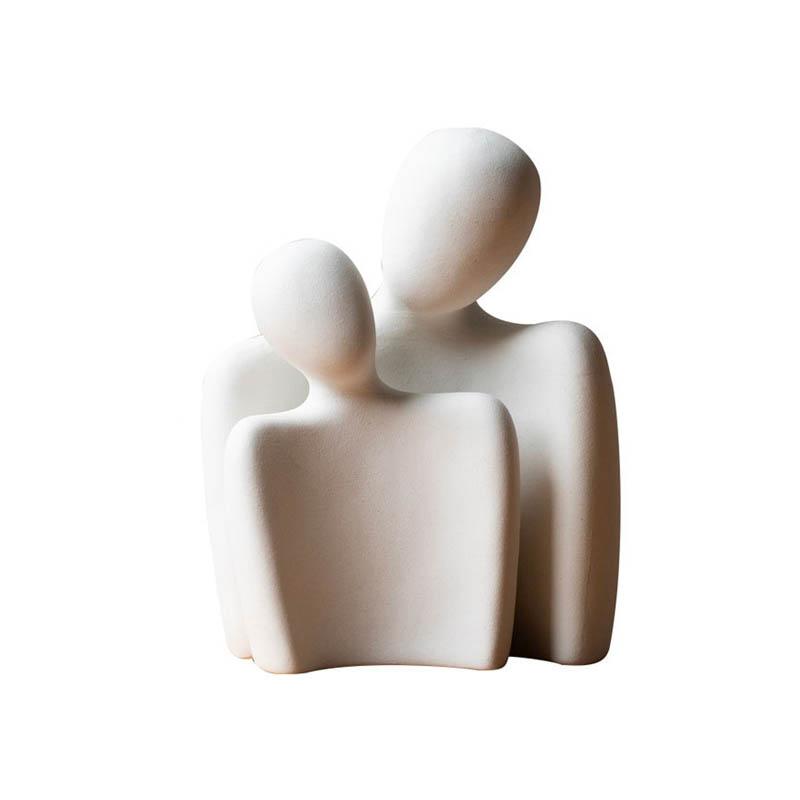Together For Life decorative figurines handcrafted from fine ceramic, symbolizing love and commitment, placed on a wooden table with a vase of flowers.