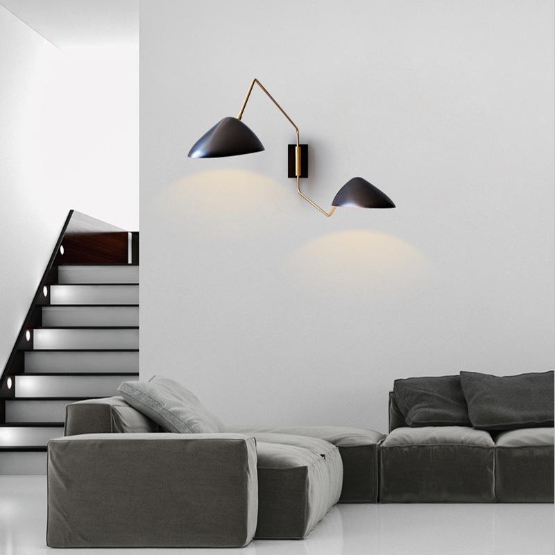 Two Arms Duckbill Wall Lamp with adjustable swing arm and asymmetrical shade in a modern living room setting.