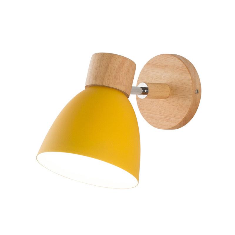 Vibrant Rotating Sconce in a cozy bedroom setting, showcasing its colorful finish.