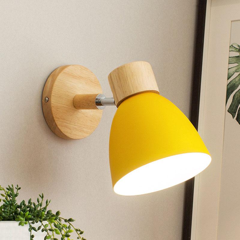 Vibrant Rotating Sconce in a cozy bedroom setting, showcasing its colorful finish.